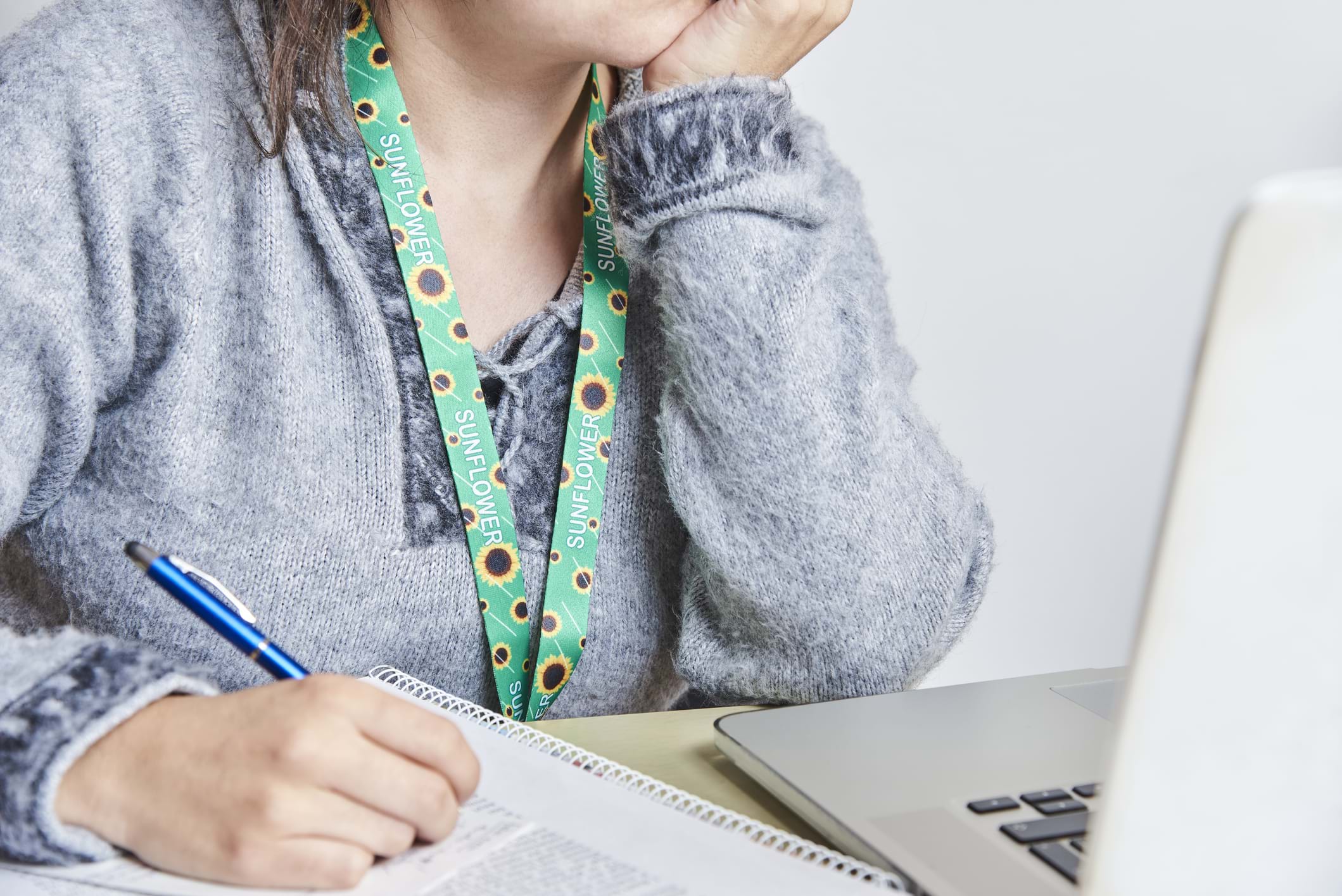 A woman wearing a sunflower lanyard